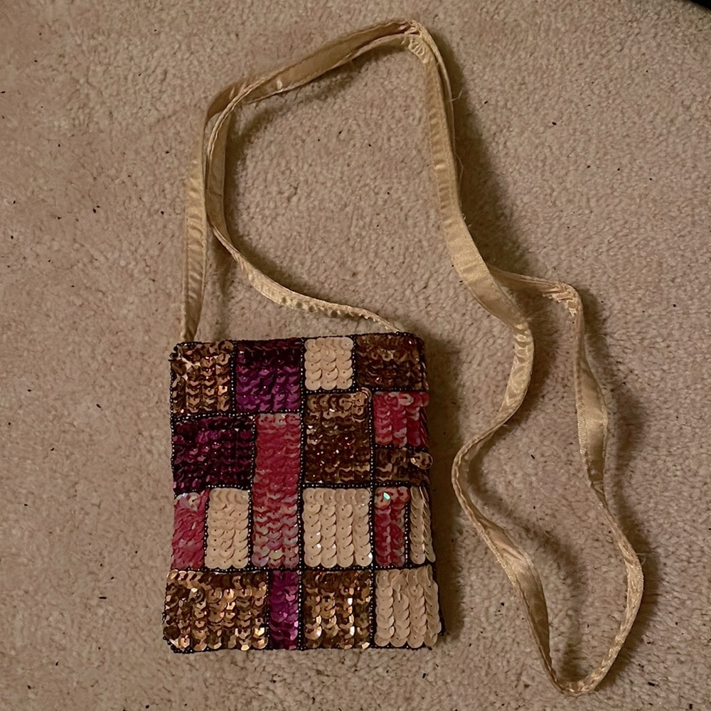 Sequin party bag with gold pink and purple tones.
